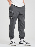 Pantalon à cordon de serrage ample de couleur unie avec poche zippée pour hommes
