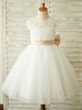 Robe cortège enfant ivoire col rond en dentelle jupe en tulle noeud sur dos à zip