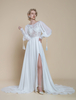 Robe de mariée bohème en dentelle découpée ligne A avec traîne taille naturelle dos nu manches longues col bijou ivoire