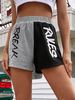 Shorts dété pour femmes Motif de lettres noires Short de sport en polyester à taille élastique