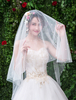 Voiles de mariée en perles Un rangée en tulle bordé de voiles de mariée ovales